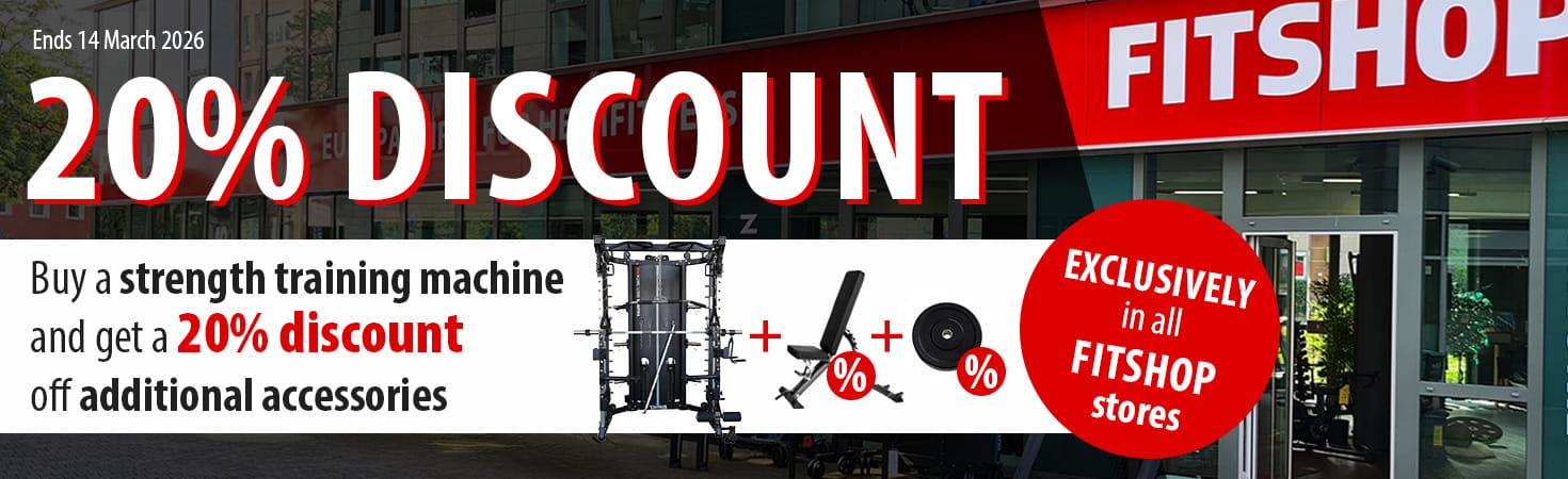 An ad banner with a Fitshop store in the background. On it is written: “Ends 14 March. 20% discount. Buy a strength training machine and get a 20% discount off additional accessories. Exclusively in all Fitshop stores.” As an example, there is a picture of a set with a multi-gym rack, a weight bench and a weight plate.