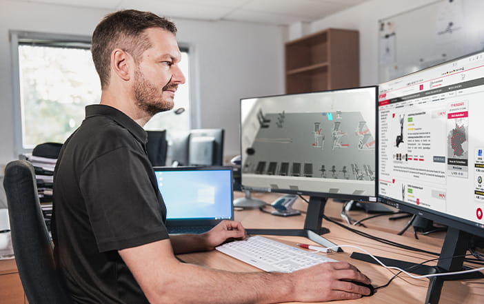 Fitshop Mitarbeiter erstellt 3D-Ansicht am Schreibtisch